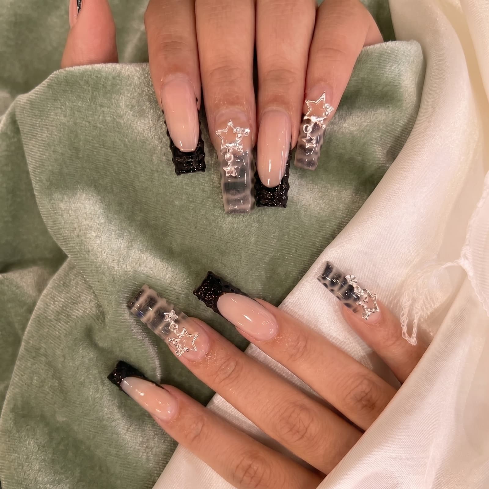 Black glitter French tips with silver star charms